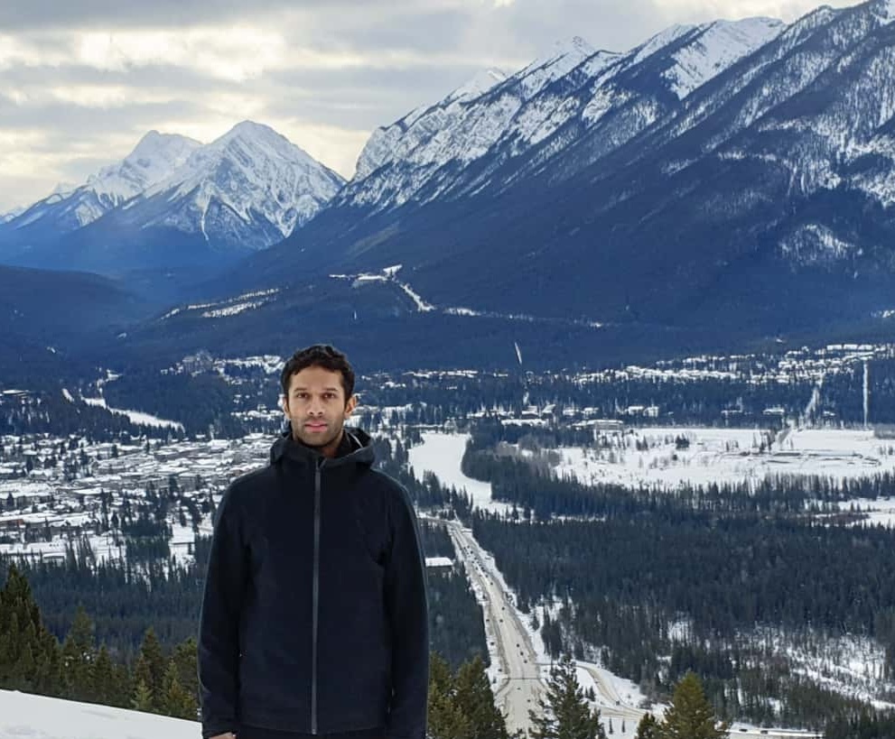 A man in Banff, Alberta in front of the rockies.