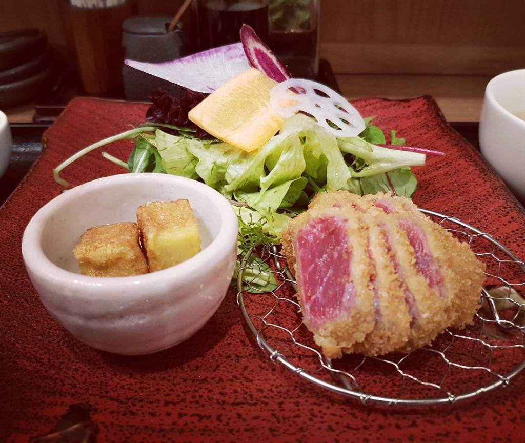 Beef cutlet (牛カツだ) alongside tofu, lotus root, radish, and lettuce. An integrated system.