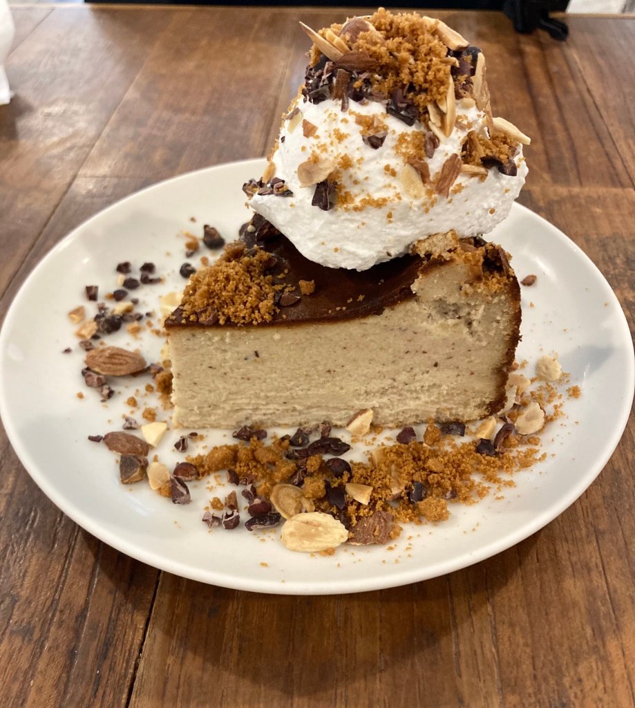 Chestnut cheesecake with cacao nibs, almond, whipped cream, and some sweet crumbles.